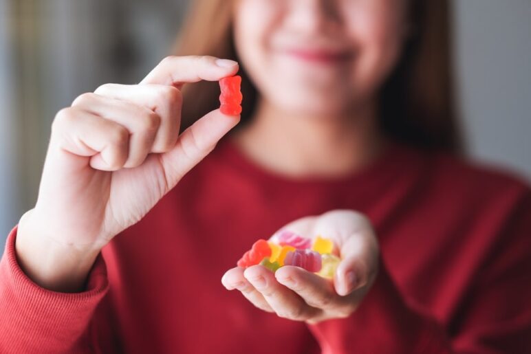 girl holding keto ACV gummy