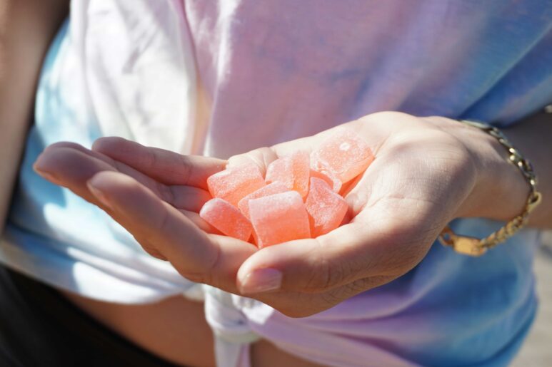 girl holding keto ACV gummies