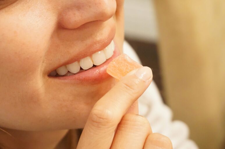 girl eating keto ACV gummies